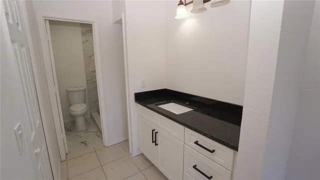 a white toilet sitting next to a shower