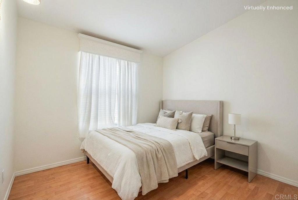 13941 Wisteria Avenue, Unit 53 Poway, CA 92064 - Photo 11 of 28 a large bed sitting in a bedroom next to a window