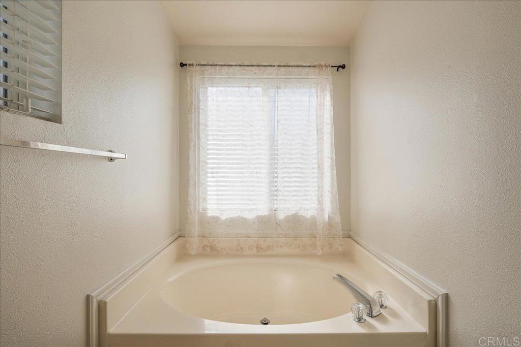 13941 Wisteria Avenue, Unit 53 Poway, CA 92064 - Photo 14 of 28 a bath tub sitting in a bathroom next to a window