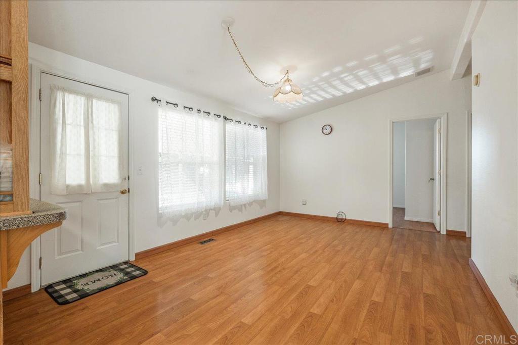 13941 Wisteria Avenue, Unit 53 Poway, CA 92064 - Photo 22 of 28 an empty room with wooden floor and windows