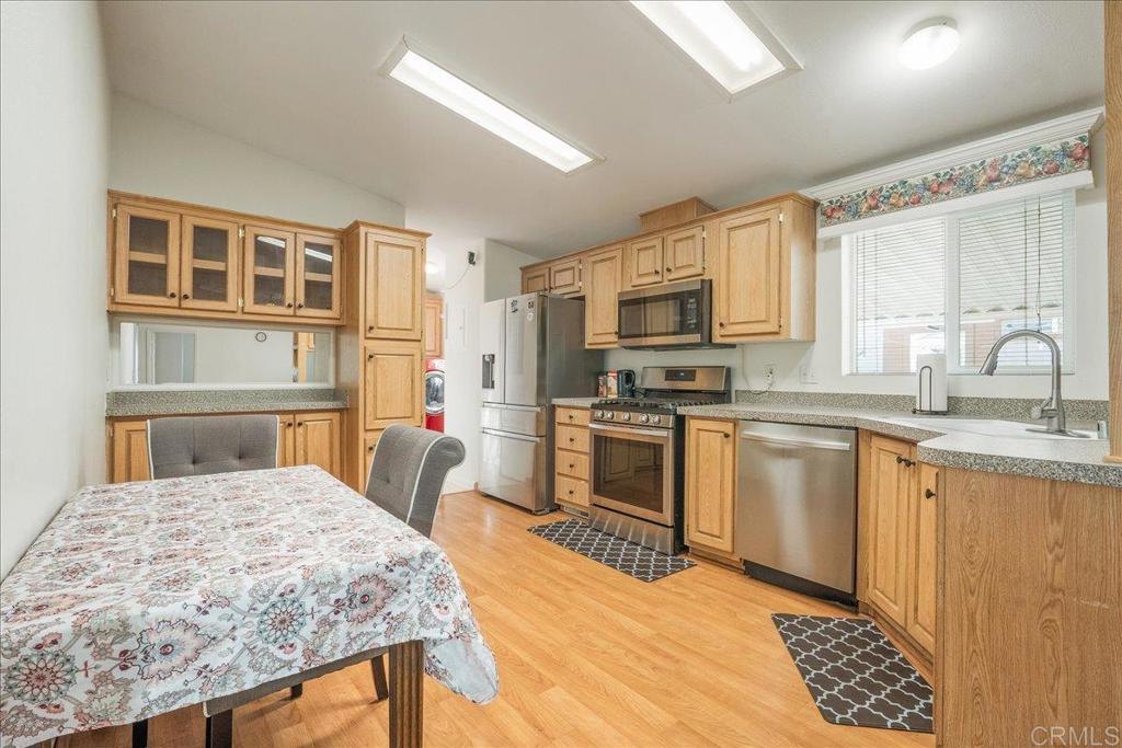 13941 Wisteria Avenue, Unit 53 Poway, CA 92064 - Photo 23 of 28 a kitchen with stainless steel appliances kitchen island granite countertop a sink and cabinets