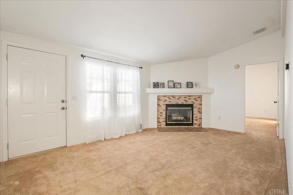 13941 Wisteria Avenue, Unit 53 Poway, CA 92064 - Photo 24 of 28 a view of an empty room with a window and fireplace