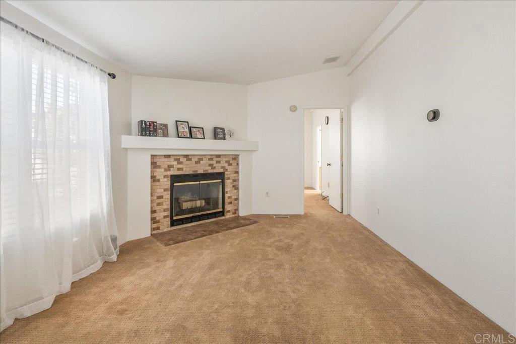 13941 Wisteria Avenue, Unit 53 Poway, CA 92064 - Photo 25 of 28 a view of an empty room with a window and fireplace