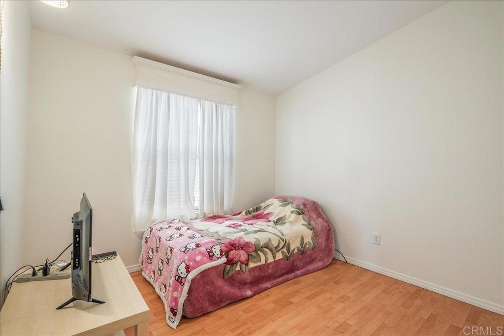 13941 Wisteria Avenue, Unit 53 Poway, CA 92064 - Photo 26 of 28 a bedroom with a bed and a window