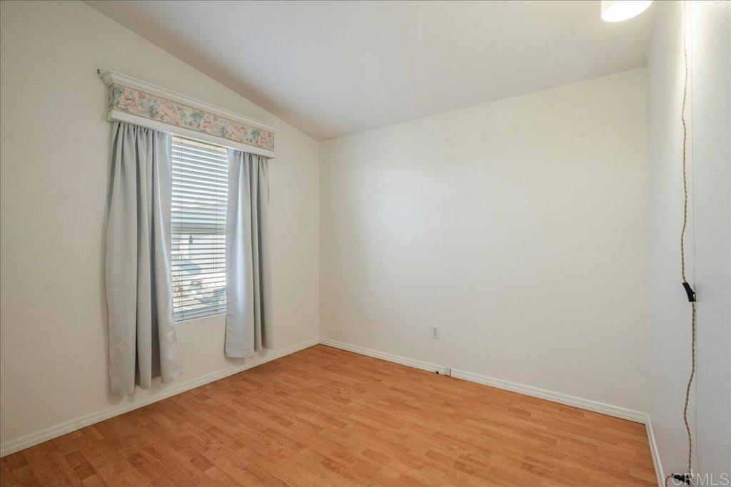 13941 Wisteria Avenue, Unit 53 Poway, CA 92064 - Photo 10 of 28 a view of empty room with wooden floor and fan