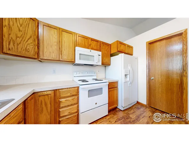 a kitchen with stainless steel appliances a stove a sink and a refrigerator