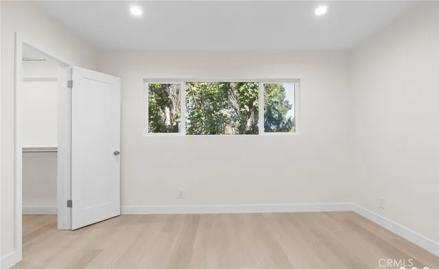 a bedroom with a bed and cabinet