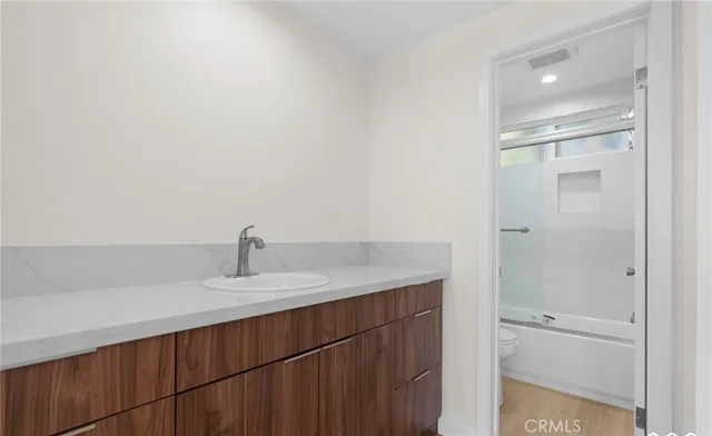 a bedroom with a bed and a potted plant