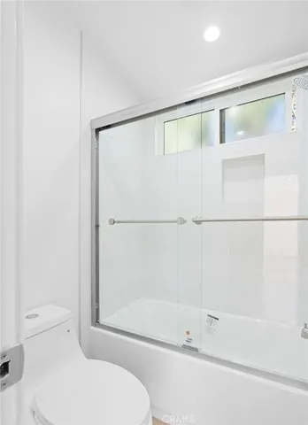 a view of a pathway of a house with backyard and wooden fence