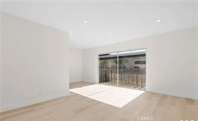 an empty room with wooden floor