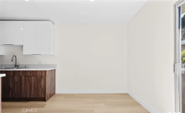 a kitchen with stainless steel appliances a stove a microwave and white cabinets