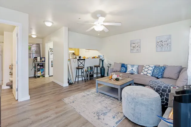 a living room with furniture and a wooden floor