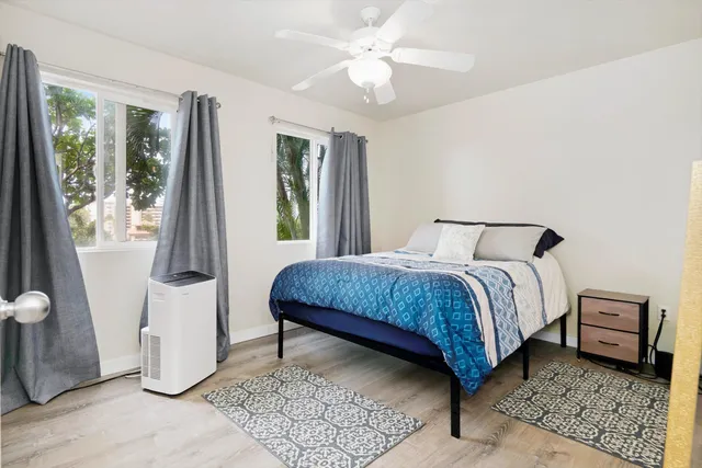 a bedroom with a bed and large mirror