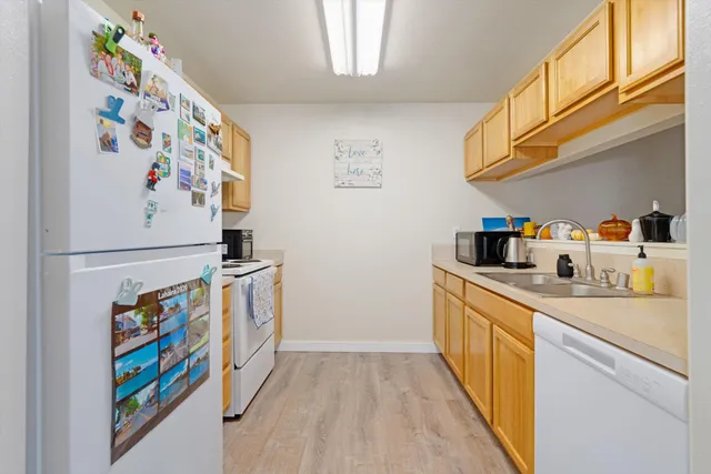 a kitchen with stainless steel appliances a stove a sink and a refrigerator