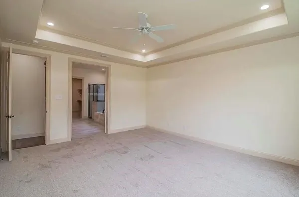 an empty room with a bathroom and a sink