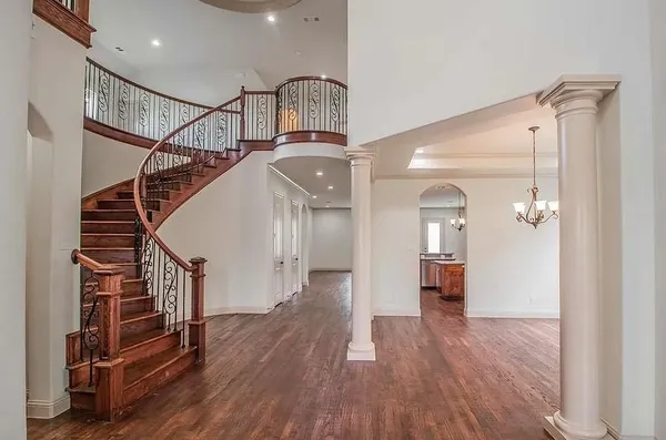a view of entryway and hall with wooden floor