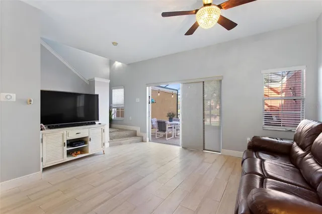 a living room with furniture and a wooden floor