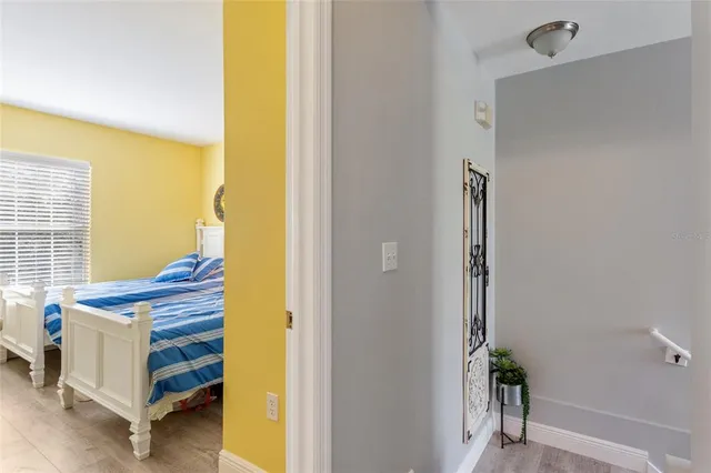 a bed room with a bed and paintings on the wall