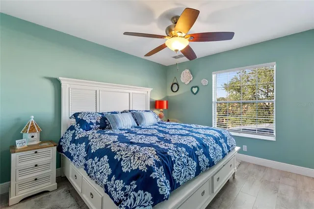 a bedroom with a bed and a chandelier