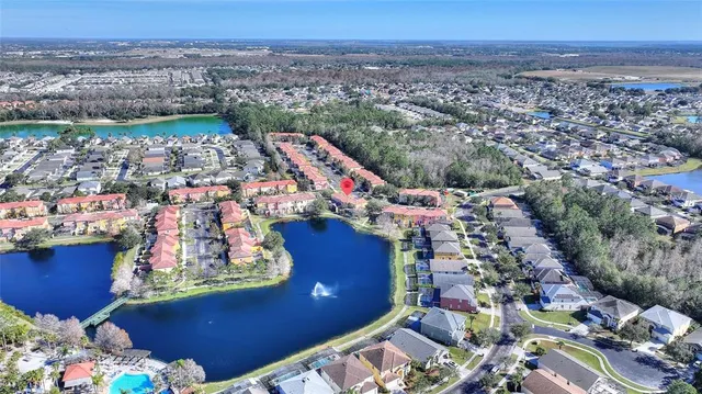 an aerial view of a house with a yard and lake view