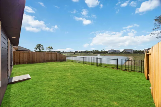 a view of a yard and a fence