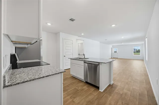 a view of kitchen with stainless steel appliances granite countertop refrigerator sink and stove