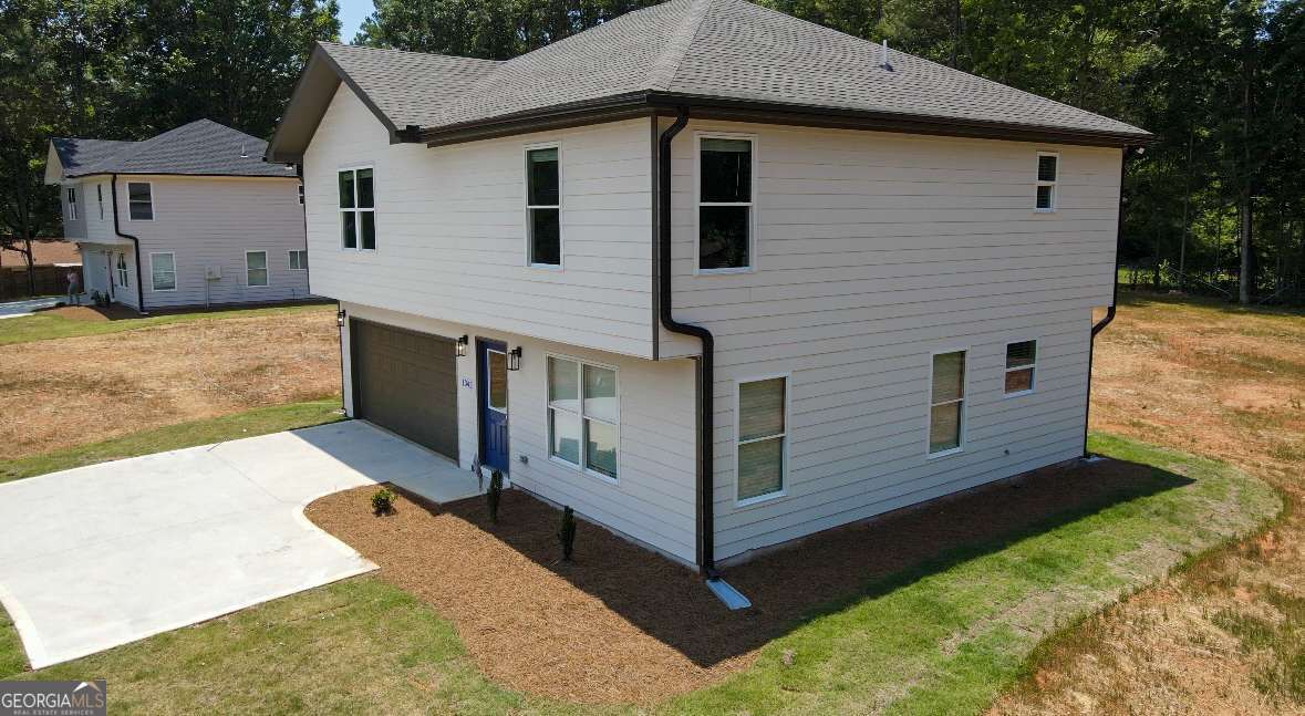 a view of a house with yard and sitting area