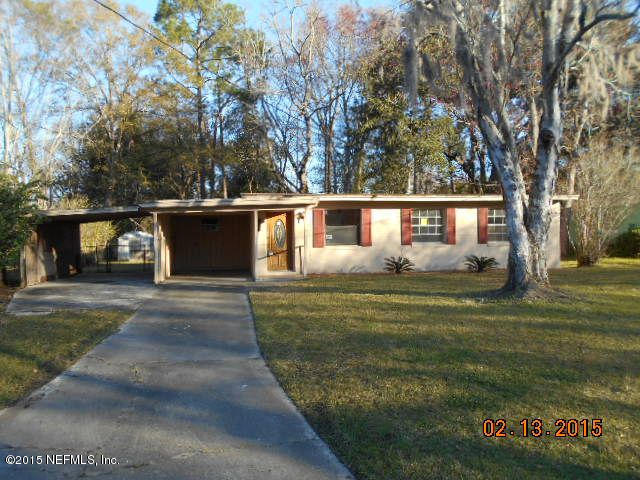 7057 Clovis Road Jacksonville, FL 32205 - Photo 1 of 12 a front view of a house with a garden