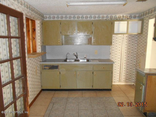 7057 Clovis Road Jacksonville, FL 32205 - Photo 3 of 12 a view of a kitchen with furniture and a fireplace