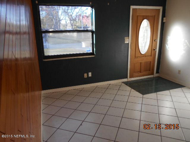 7057 Clovis Road Jacksonville, FL 32205 - Photo 8 of 12 a bedroom with a bed and a mirror