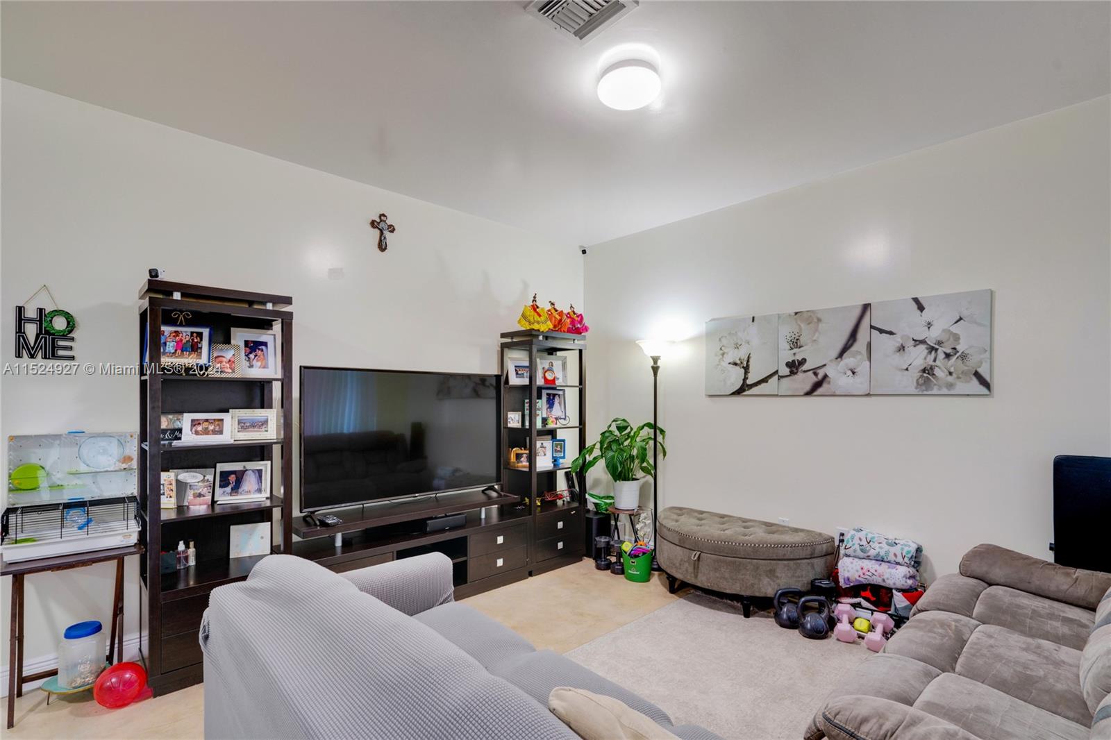 10129 West Jessamine Street Miami, FL 33157 - Photo 11 of 50 a living room with furniture and a flat screen tv