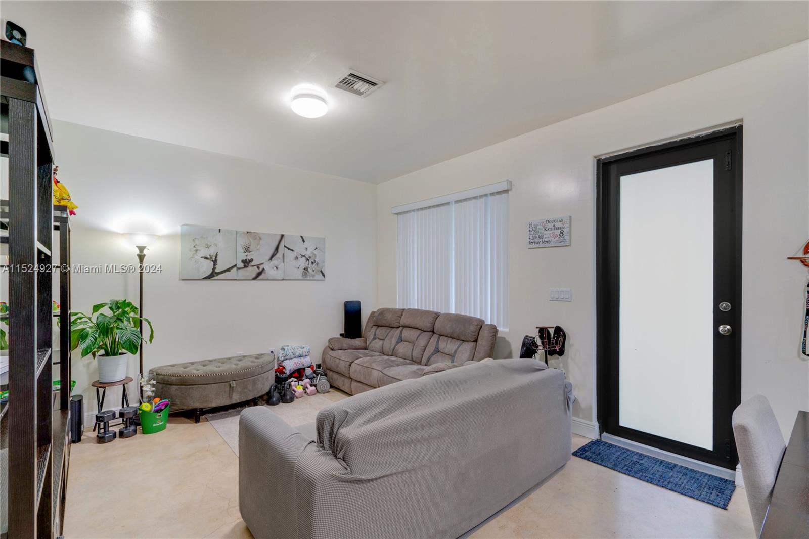 10129 West Jessamine Street Miami, FL 33157 - Photo 12 of 50 a living room with furniture and flowers