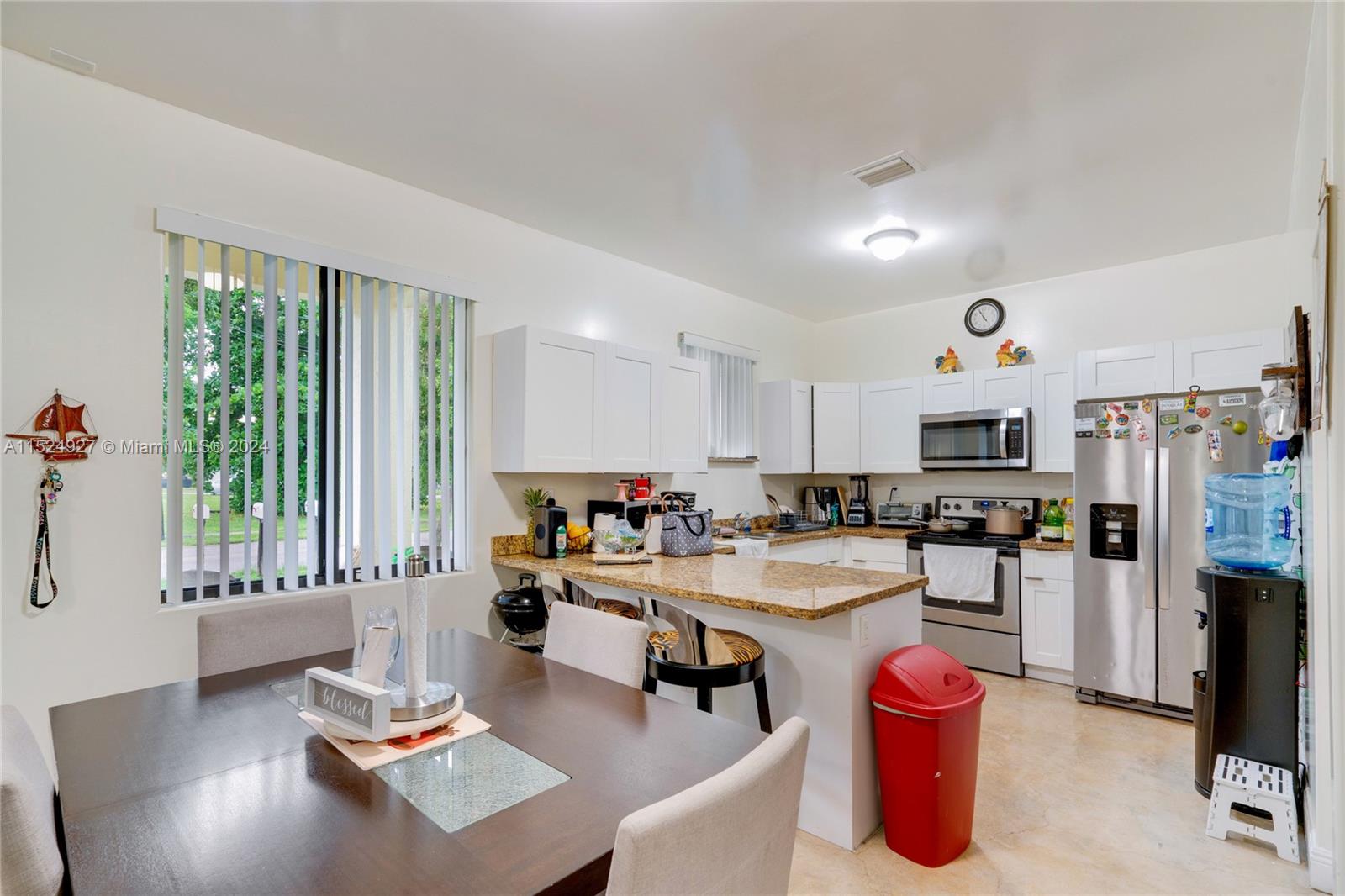 10129 West Jessamine Street Miami, FL 33157 - Photo 13 of 50 a kitchen with sink refrigerator and large window