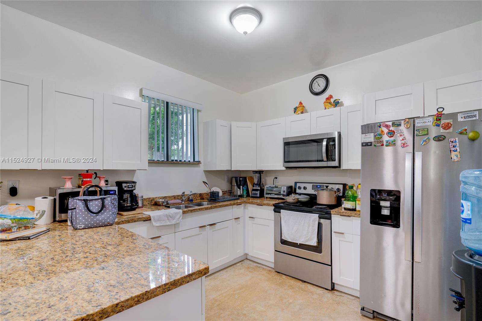 10129 West Jessamine Street Miami, FL 33157 - Photo 15 of 50 a kitchen with refrigerator and cabinets