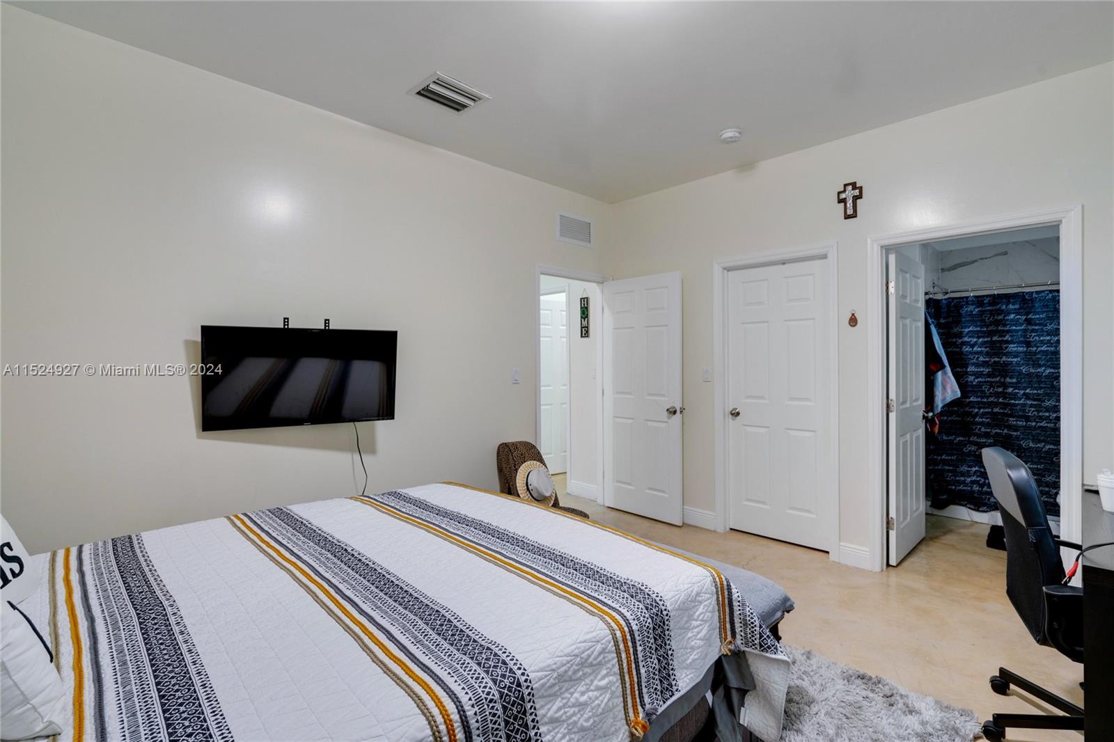 10129 West Jessamine Street Miami, FL 33157 - Photo 18 of 50 a bedroom with a bed and a flat screen tv