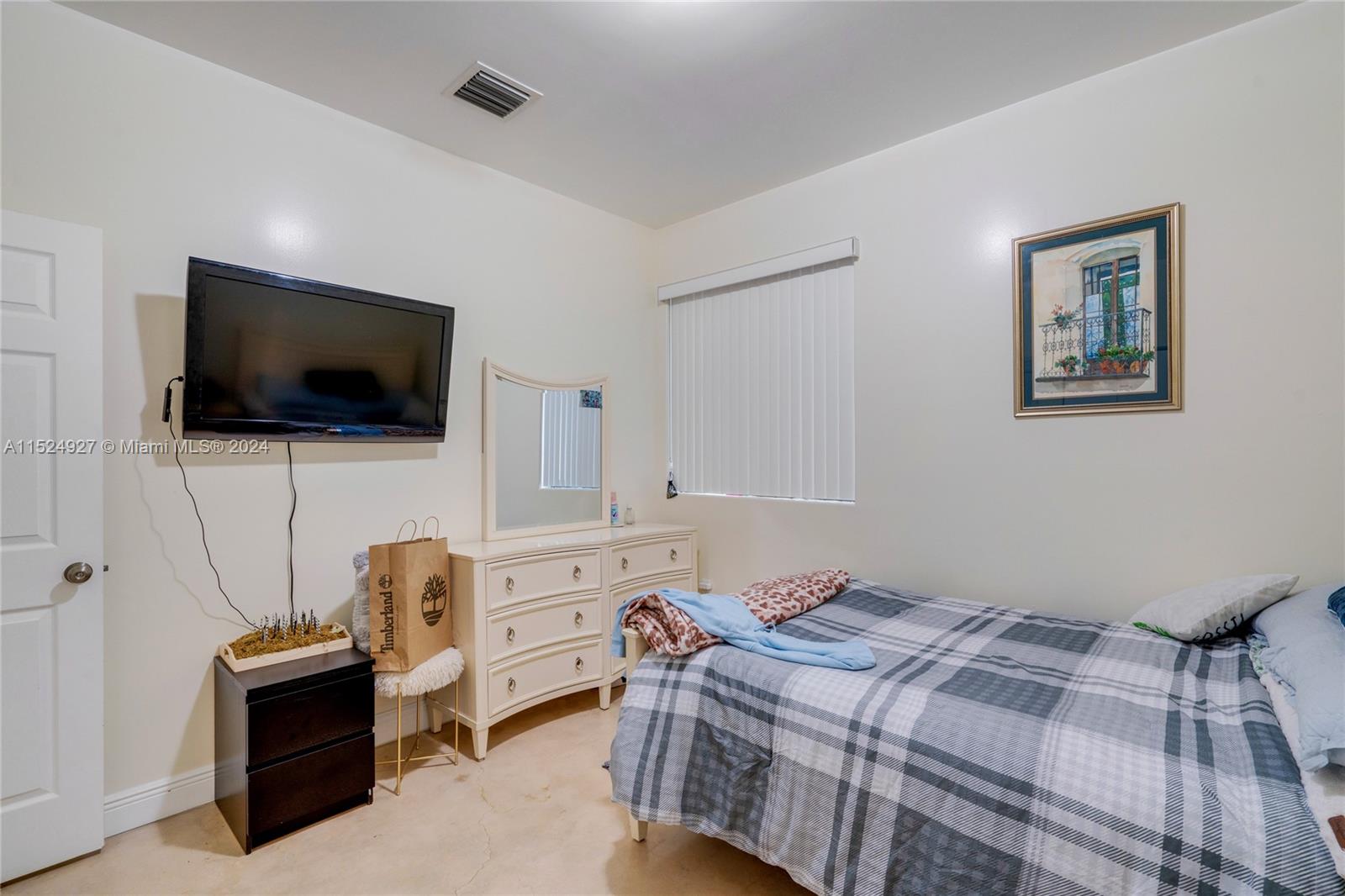 10129 West Jessamine Street Miami, FL 33157 - Photo 23 of 50 a bedroom with a bed and a flat screen tv