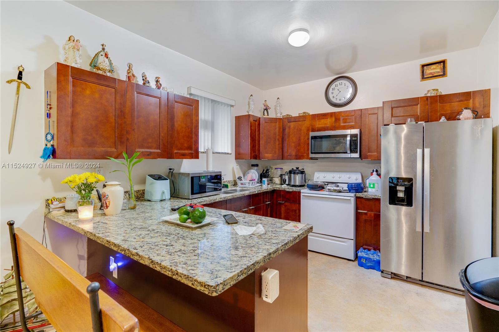 10129 West Jessamine Street Miami, FL 33157 - Photo 28 of 50 a kitchen with stainless steel appliances granite countertop a refrigerator a stove top oven a sink and dishwasher
