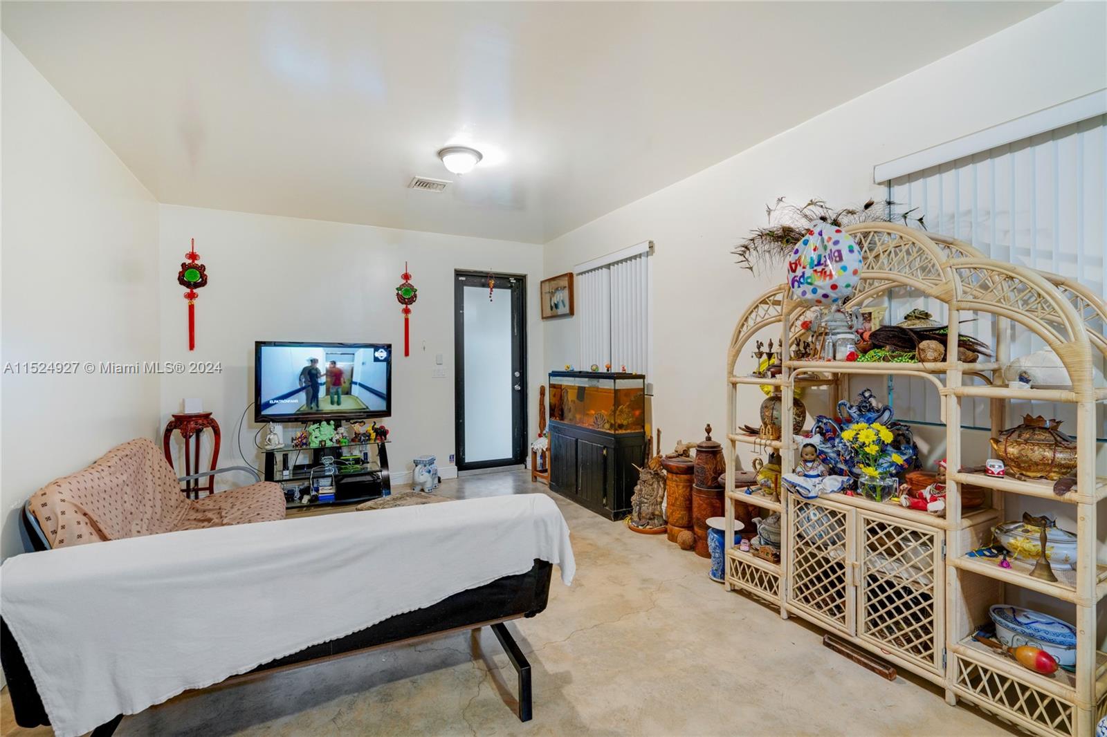 10129 West Jessamine Street Miami, FL 33157 - Photo 29 of 50 a living room with lots of furniture and a flat screen tv