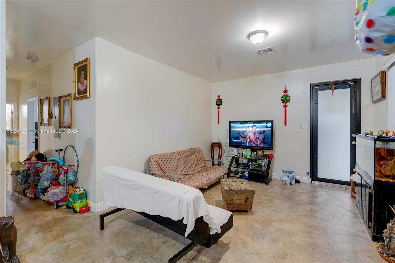10129 West Jessamine Street Miami, FL 33157 - Photo 30 of 50 a living room with furniture and a flat screen tv