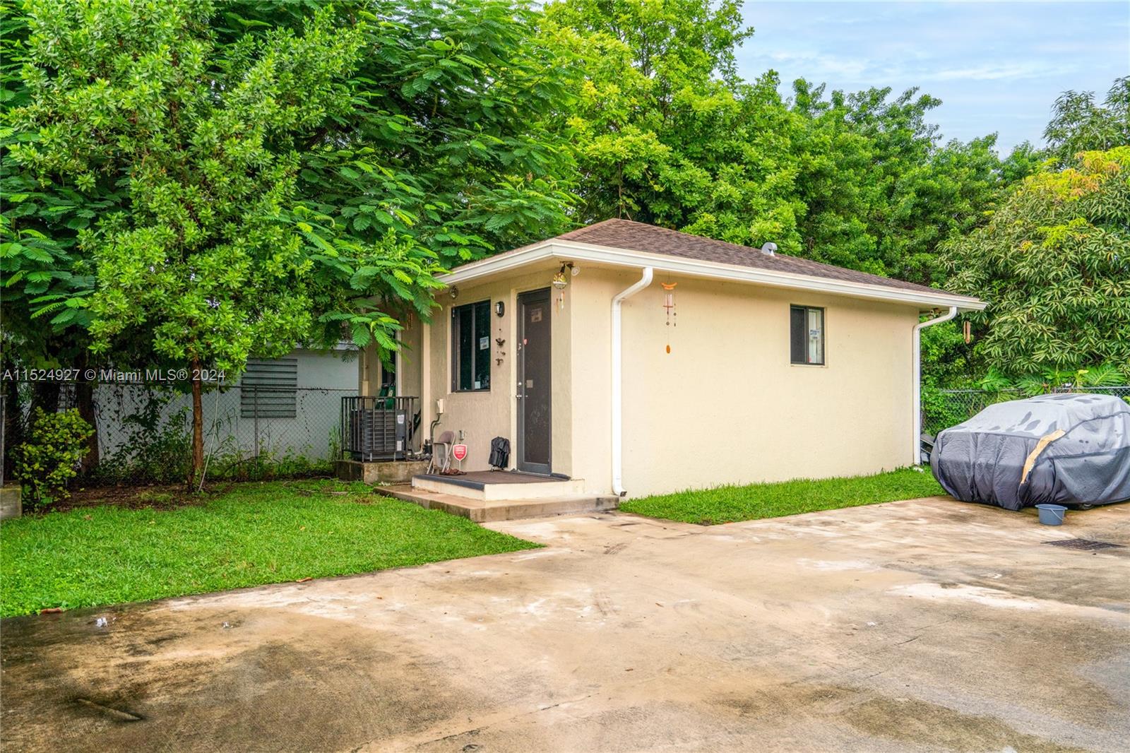 10129 West Jessamine Street Miami, FL 33157 - Photo 3 of 50 a front view of a house with a yard and garage