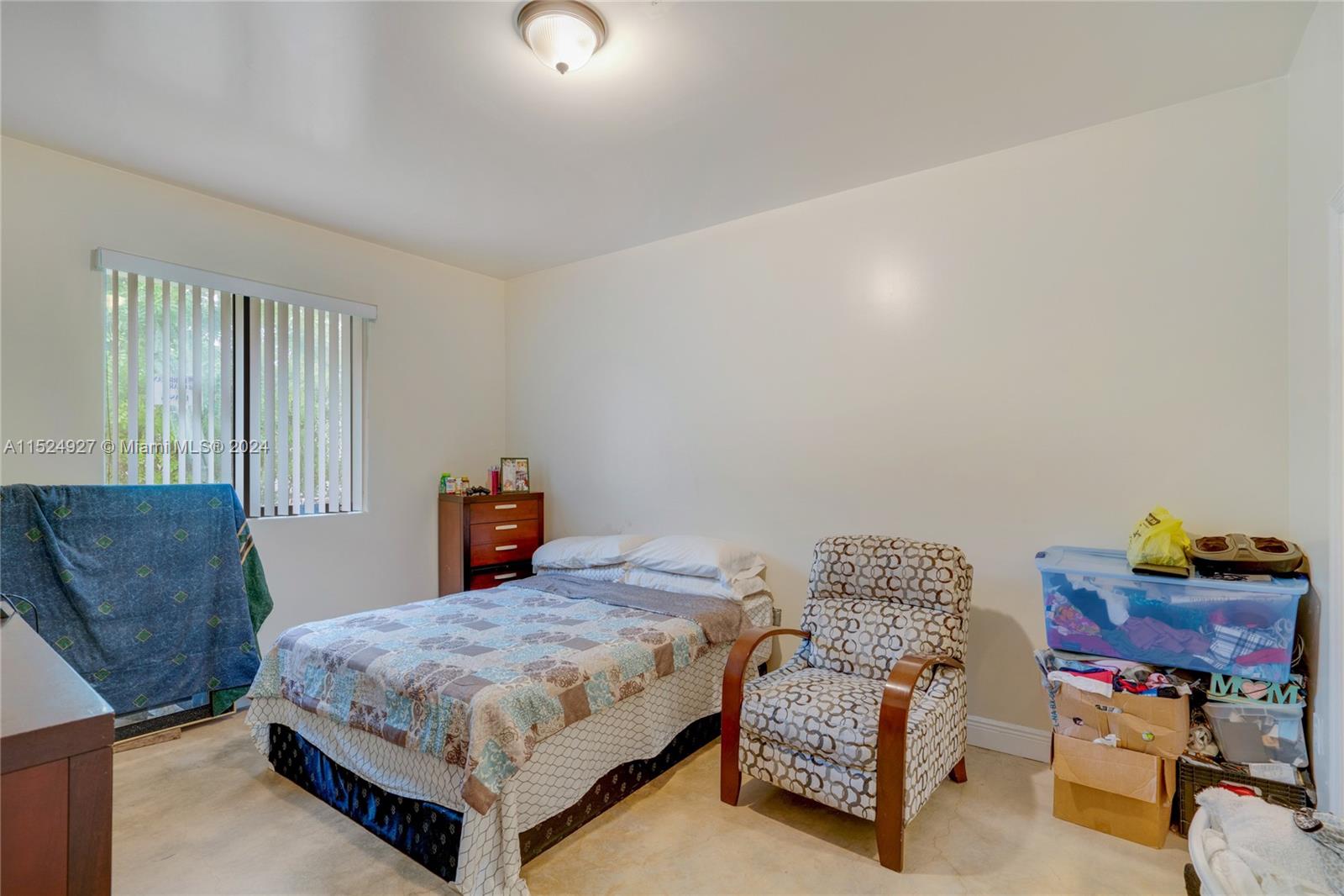 10129 West Jessamine Street Miami, FL 33157 - Photo 31 of 50 a bedroom with a bed and dresser