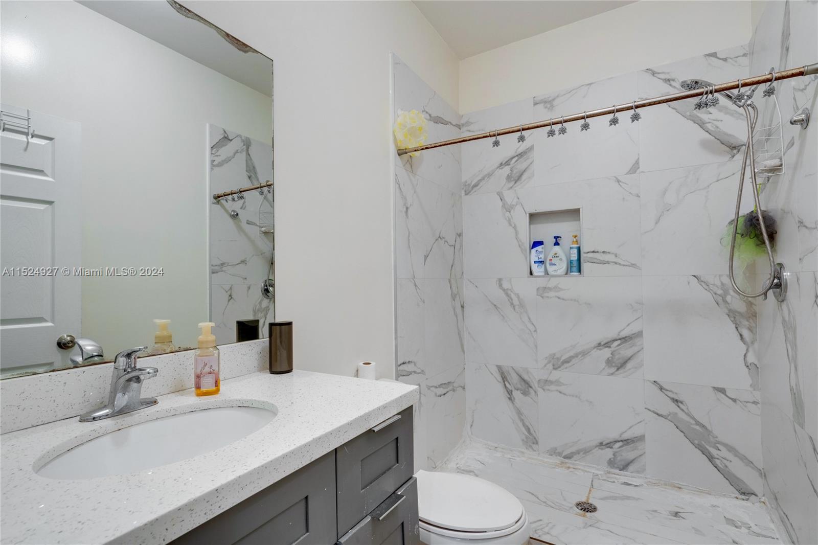 10129 West Jessamine Street Miami, FL 33157 - Photo 32 of 50 a bathroom with a sink toilet and shower