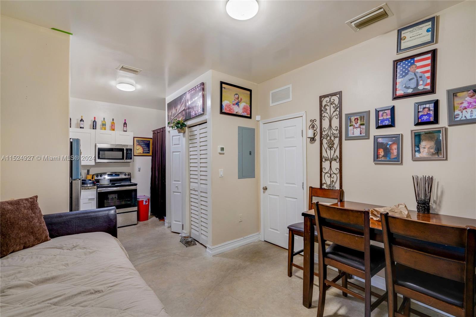 10129 West Jessamine Street Miami, FL 33157 - Photo 42 of 50 a living room with furniture and paintings on the wall