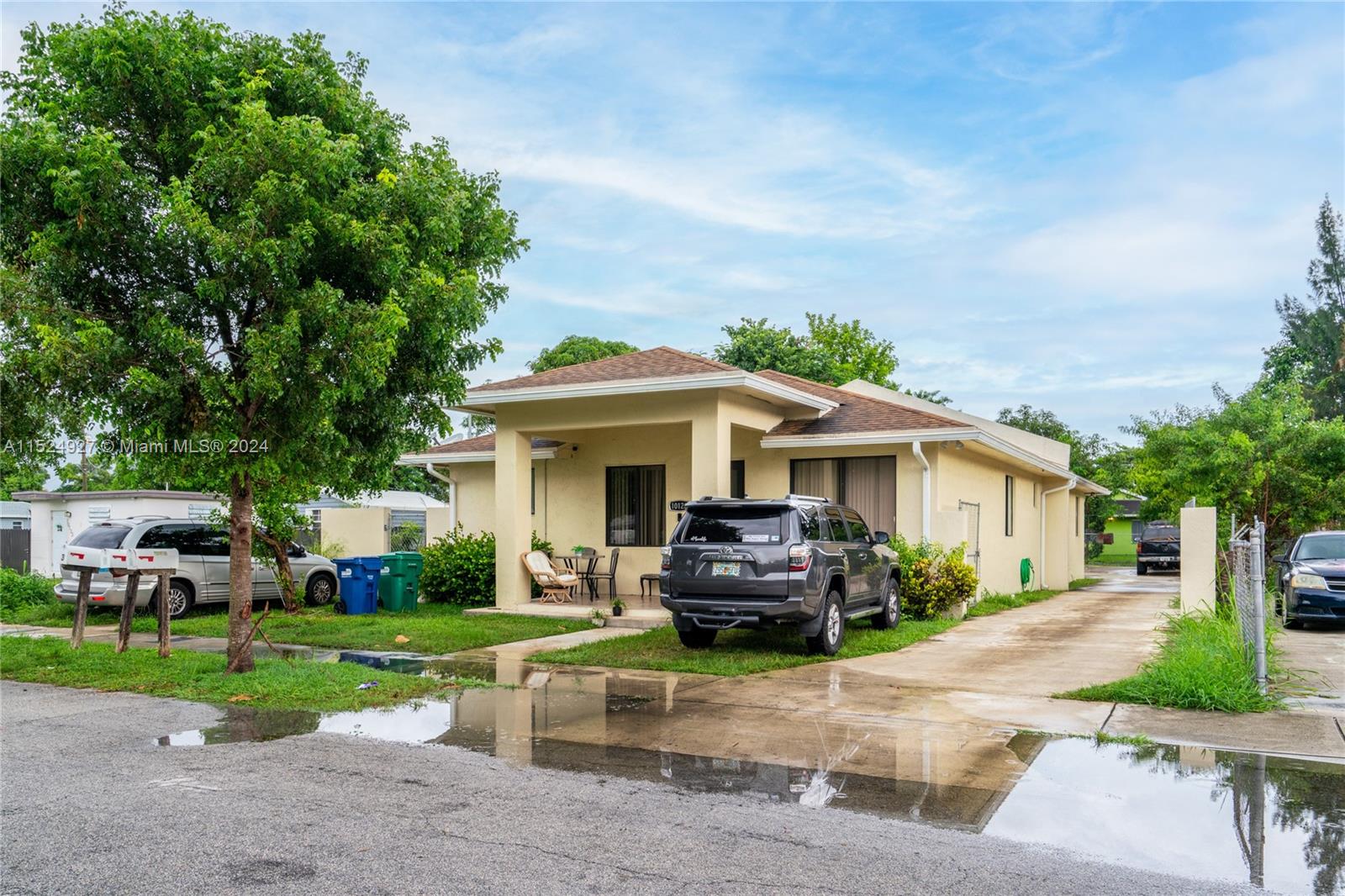10129 West Jessamine Street Miami, FL 33157 - Photo 7 of 50 a front view of a house with a garden and trees