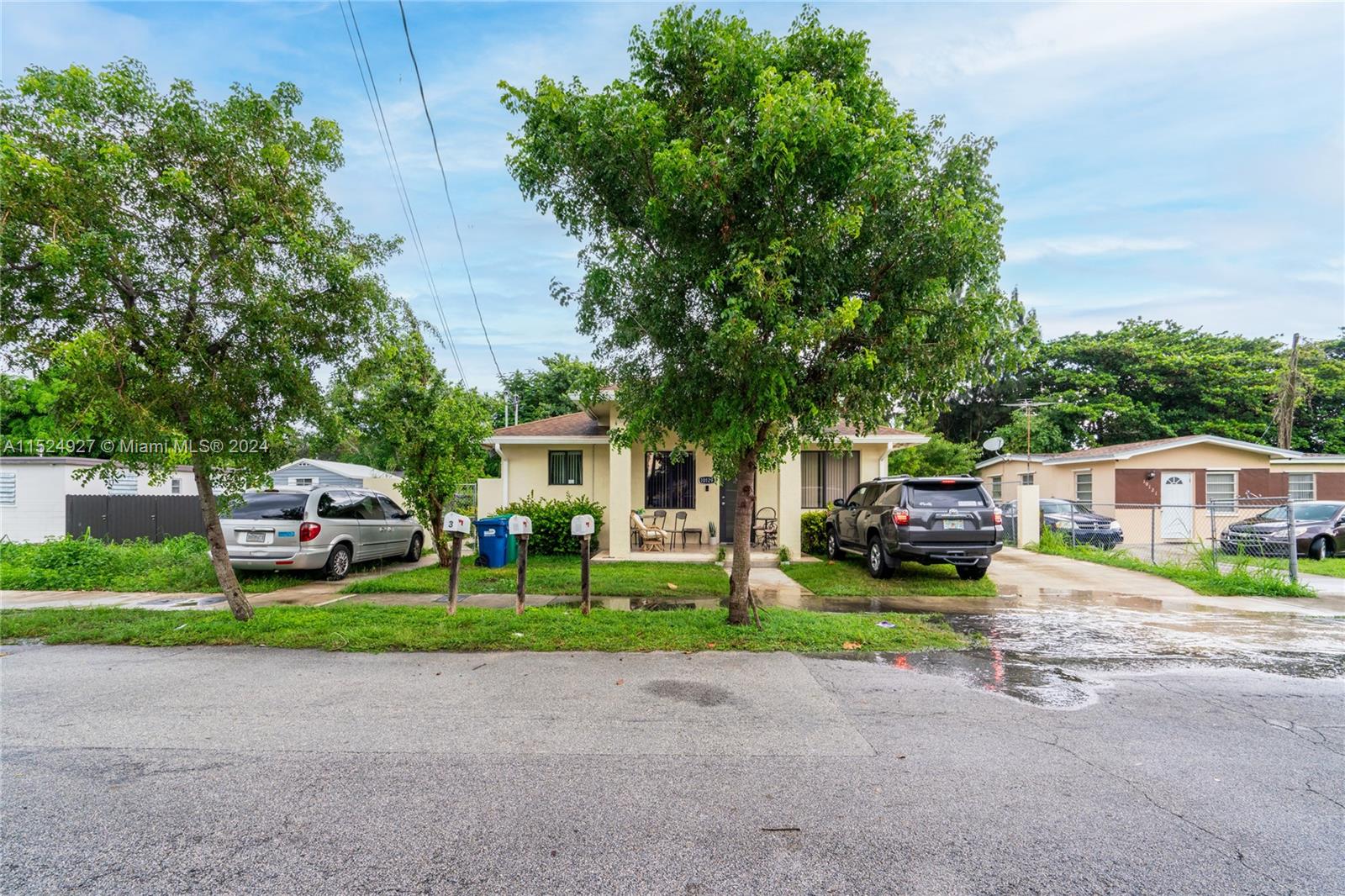 10129 West Jessamine Street Miami, FL 33157 - Photo 9 of 50 a car parked in front of a house with a small yard