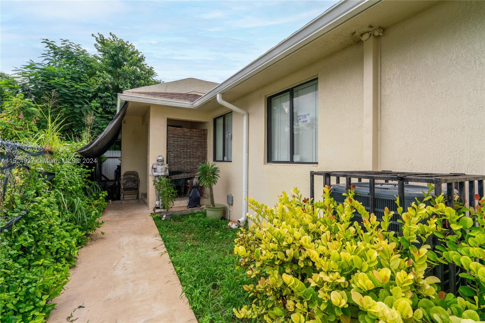 10129 West Jessamine Street Miami, FL 33157 - Photo 10 of 50 a front view of a house with garden
