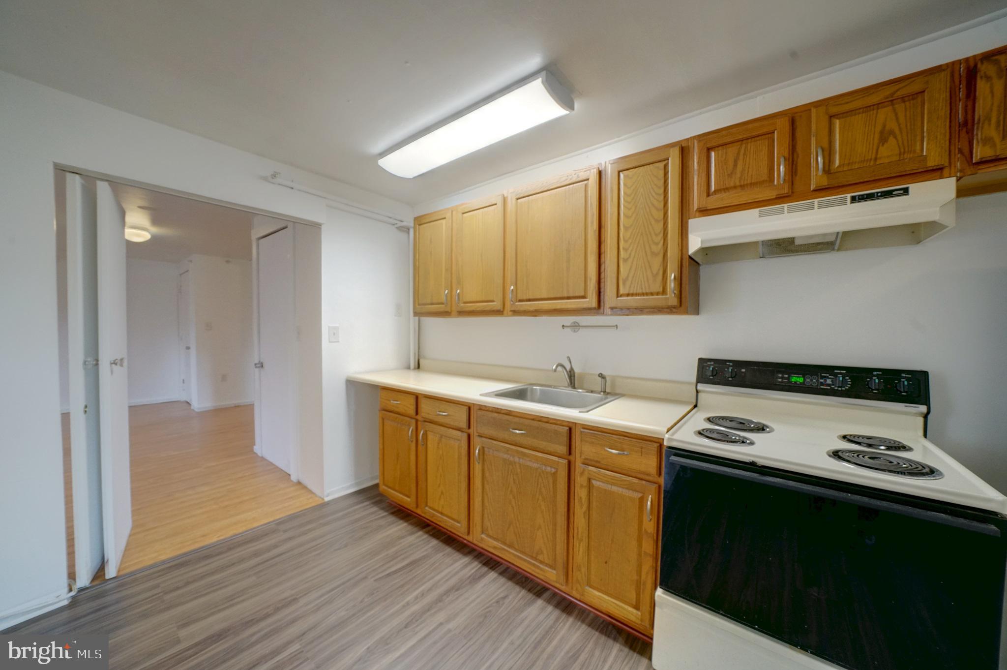 2793 Pfefferkorn Road, Unit D West Friendship, MD 21794 - Photo 11 of 24 a kitchen with a sink cabinets and wooden floor