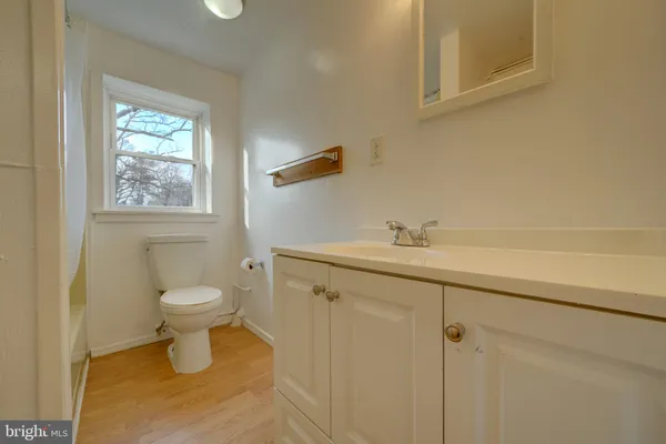 a bathroom with a toilet sink and window