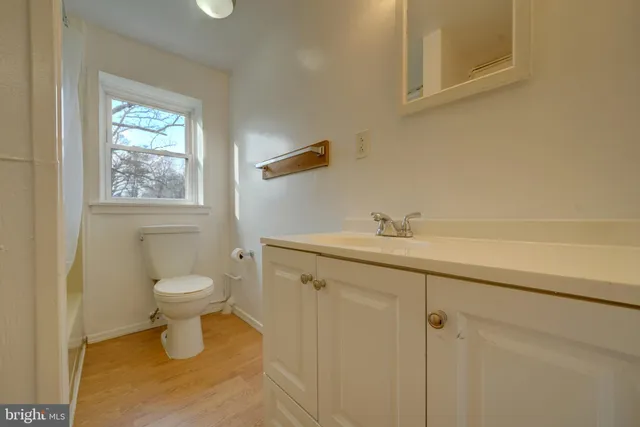 a bathroom with a toilet sink and window