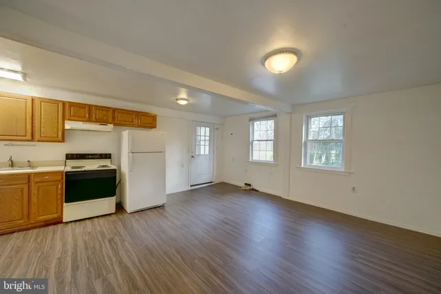 a view of a kitchen with a sink and a stove top oven